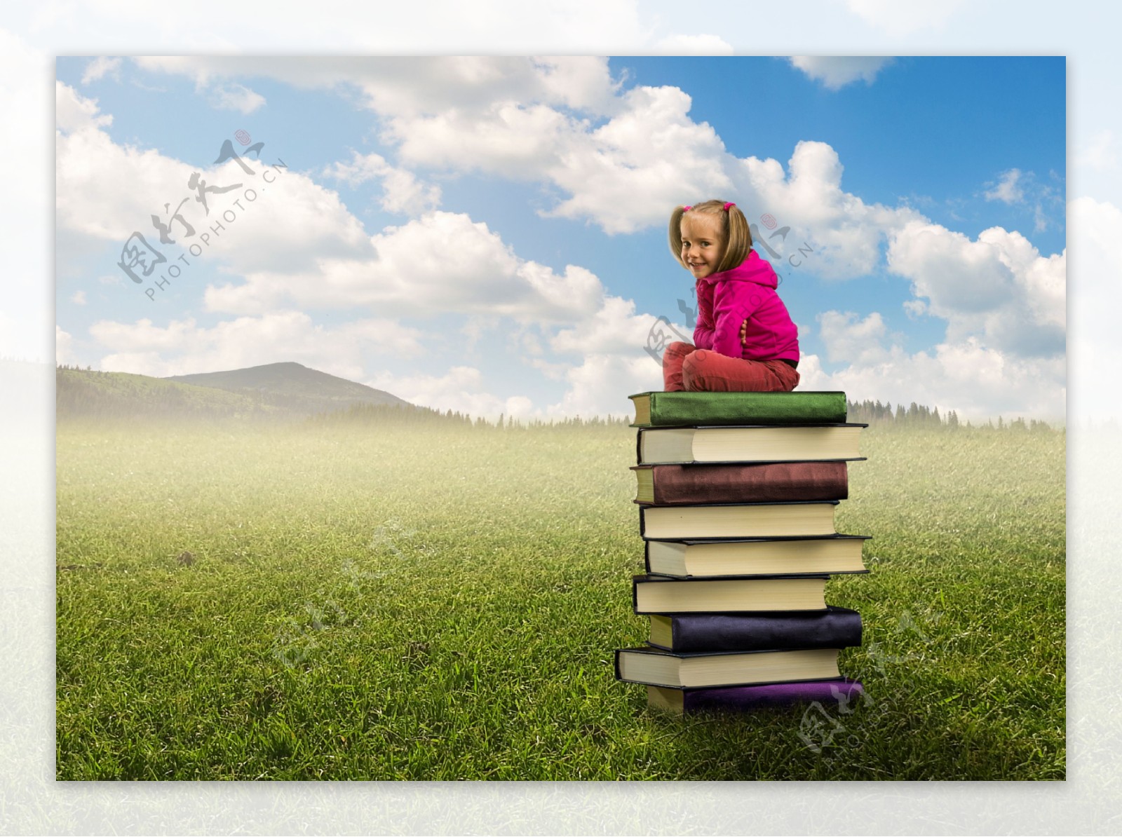 坐在书本上的小女孩图片