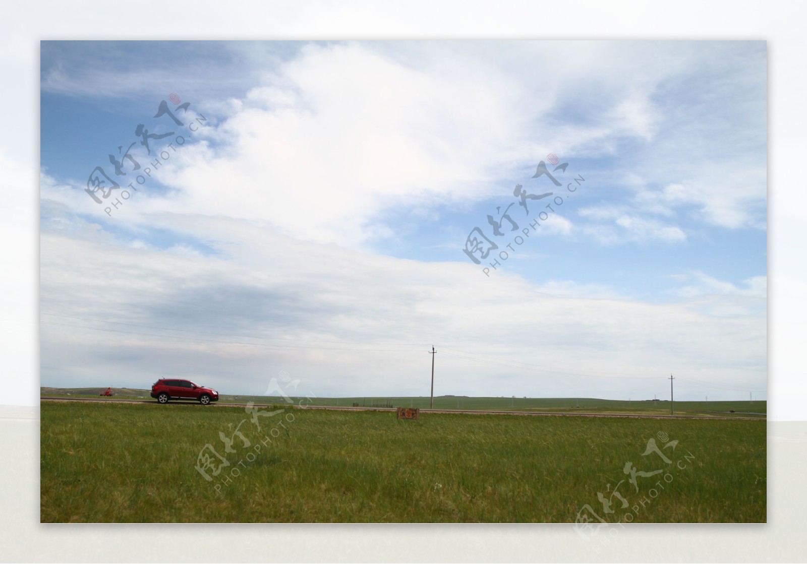 田园公路上的红色轿车图片